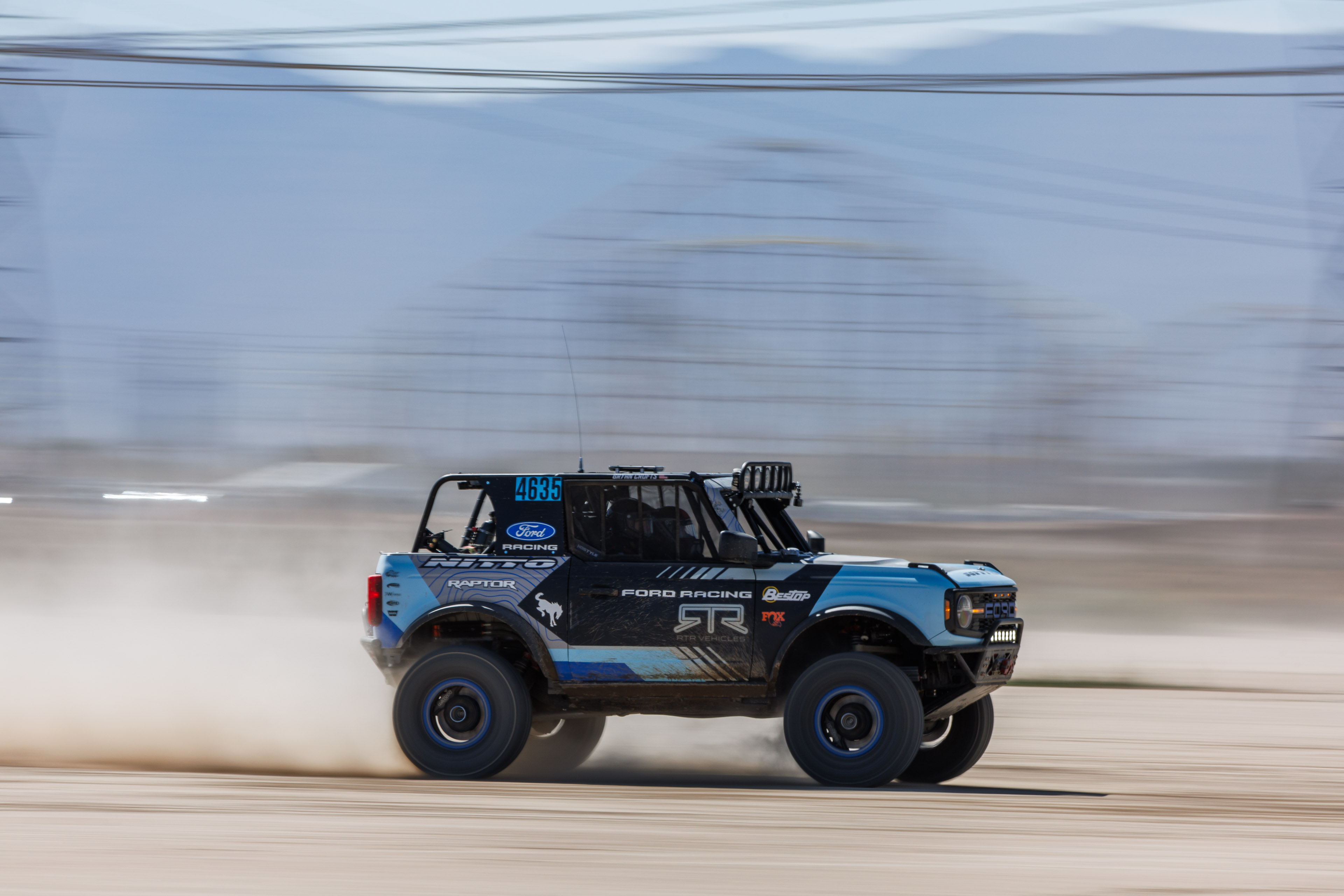 Mint 400 - Bailey Campbell races across desert with iconic rollercoaster behind